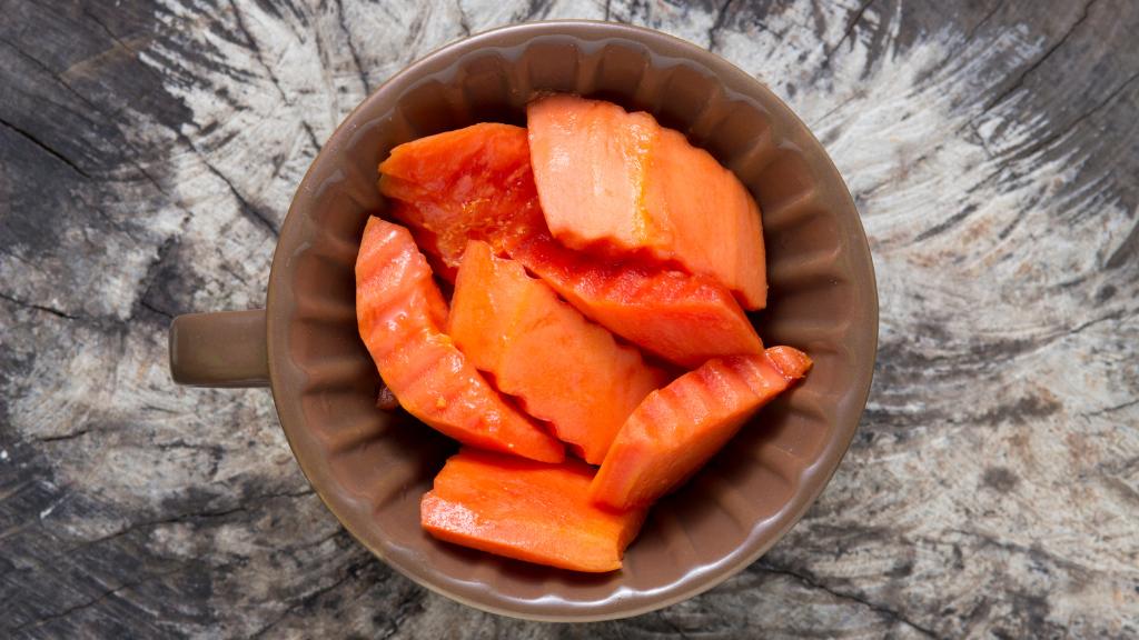 Dogs can eat papaya. It’s healthy and adds a boost of plant-based nutrients to your pup’s diet. It has a low sugar content, antioxidant properties, and can support digestive health with other nutrients that your dog food may not have.